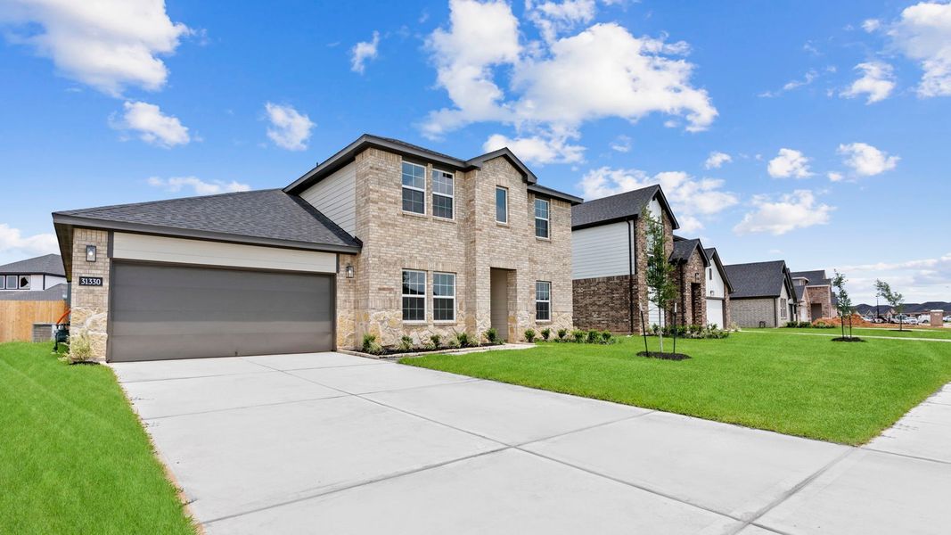 Front exterior of a new home in Tamarron, Fulshear, TX, highlighting curb appeal (Image 26).