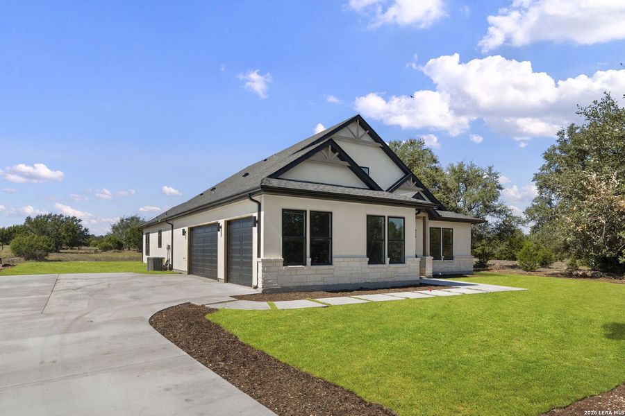 Front exterior of a new home in , Bandera, TX, highlighting curb appeal (Image 27).