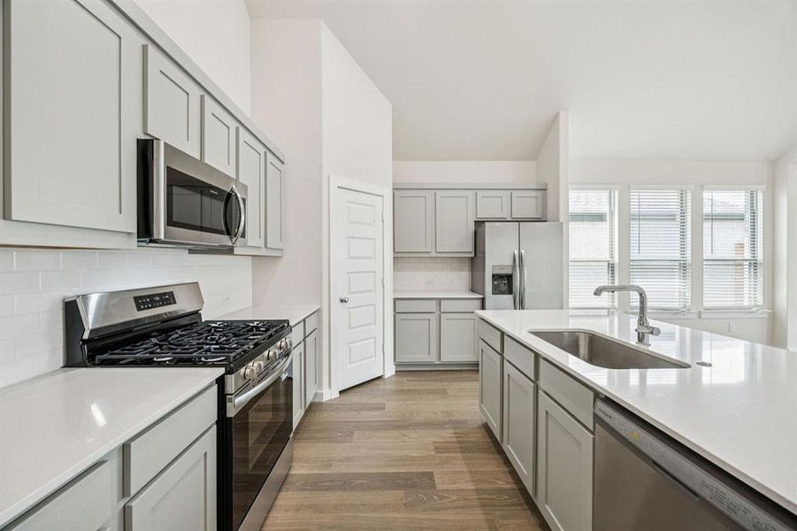 Kitchen in the Claret home plan by Trophy Signature Homes – REPRESENTATIVE PHOTO