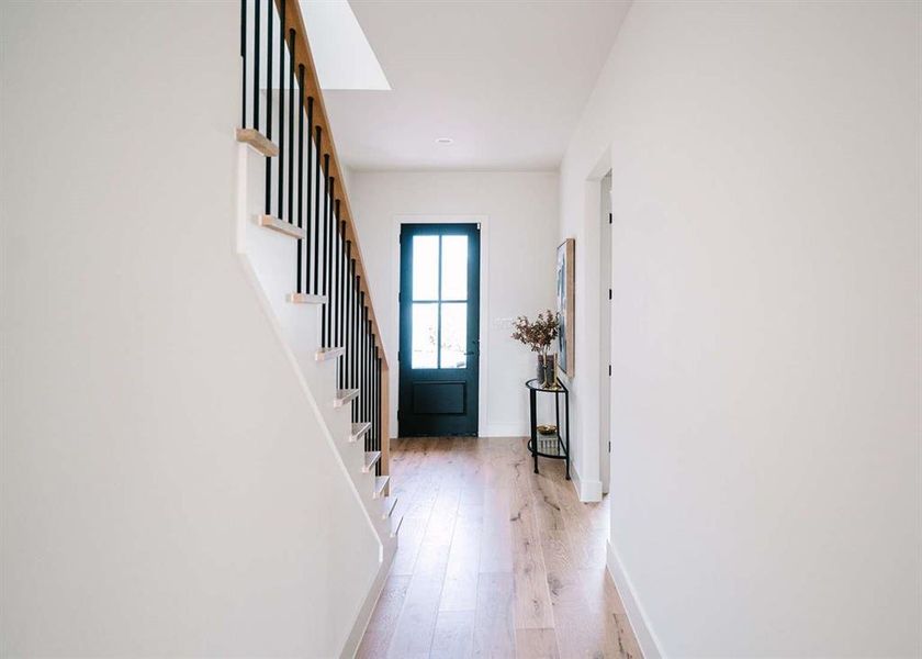 Entrance foyer with light hardwood / wood-style floors