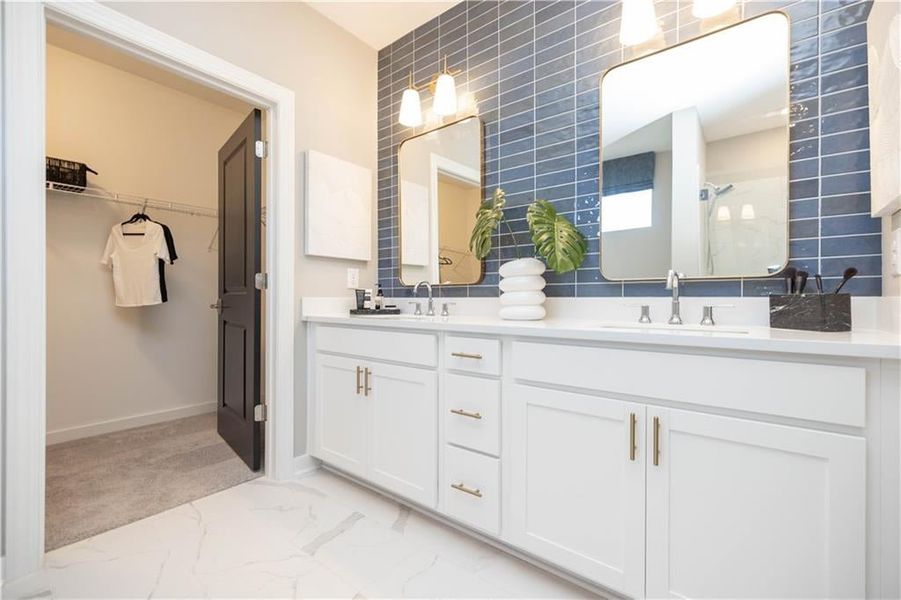 Primary bathroom leads into your walk in closet. Not actual home. Photos of Model Home.