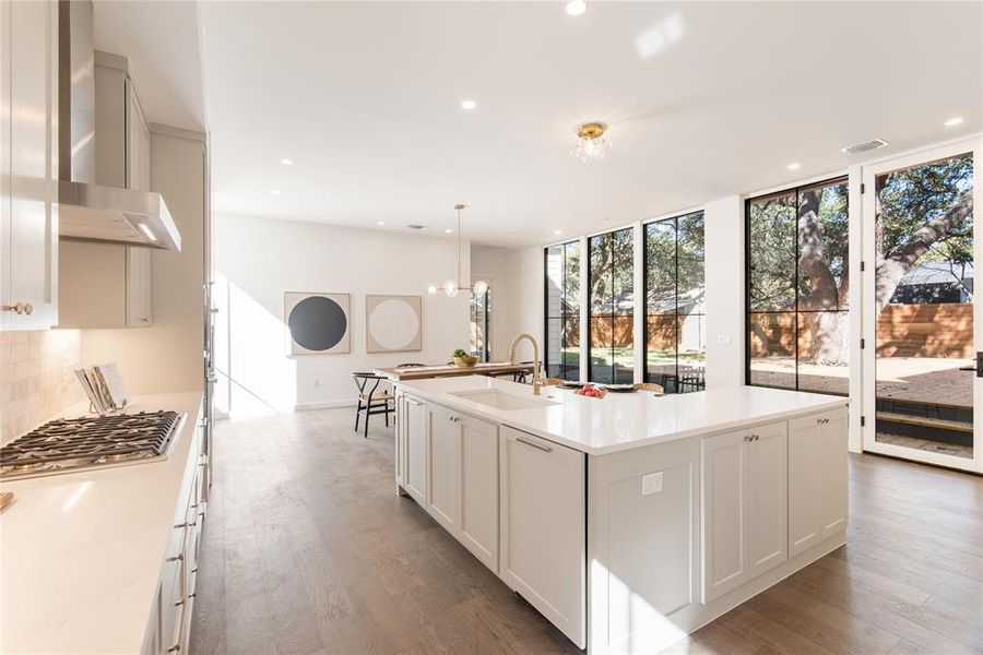 Large center island has a paneled dishwasher, storage galore, and killer views through those aforementioned floor-to-ceiling windows.