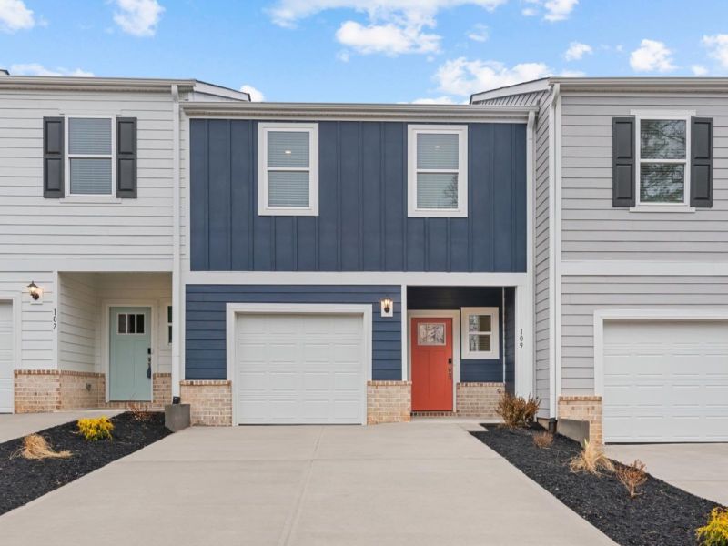 Front exterior of a new home in Crossing at Abner Creek Townes, Greer, SC, highlighting curb appeal (Image 1). Front exterior of a new home in Crossing at Abner Creek Townes, Greer, SC, highlighting curb appeal (Image 1).