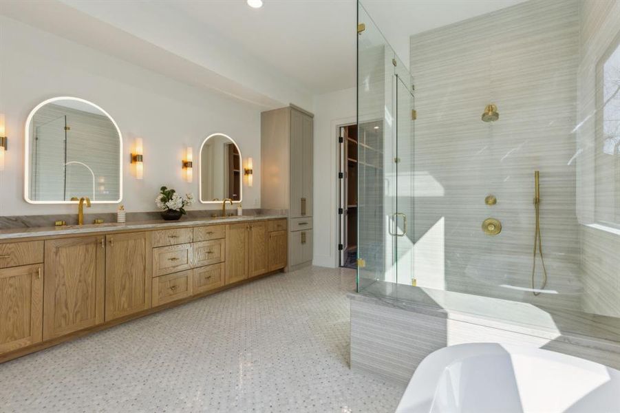 Bathroom featuring vanity and independent shower and bath