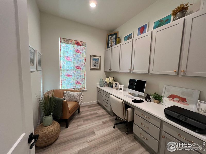 Dedicated main level office with door and custom blind Dedicated main level office with door and custom blind