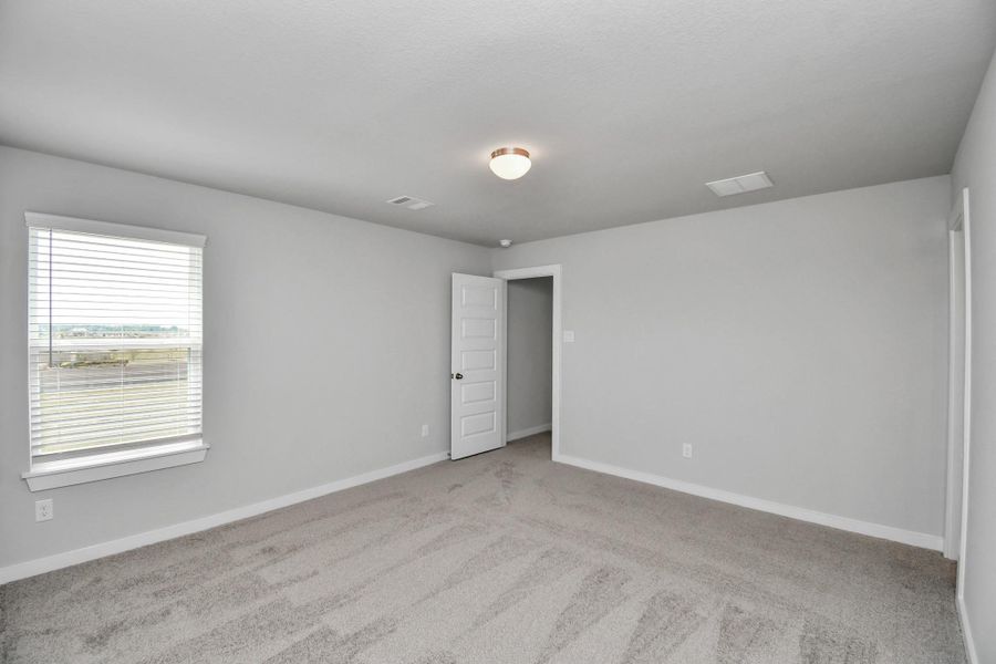 Generously sized secondary bedrooms featuring spacious closets, soft and inviting carpeting underfoot, large windows allowing plenty of natural light, and the added touch of privacy blinds for your personal retreat.