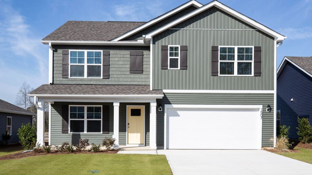 Front exterior of a new home in Saltgrass Landing, Winnabow, NC, highlighting curb appeal (Image 1). Front exterior of a new home in Saltgrass Landing, Winnabow, NC, highlighting curb appeal (Image 1).