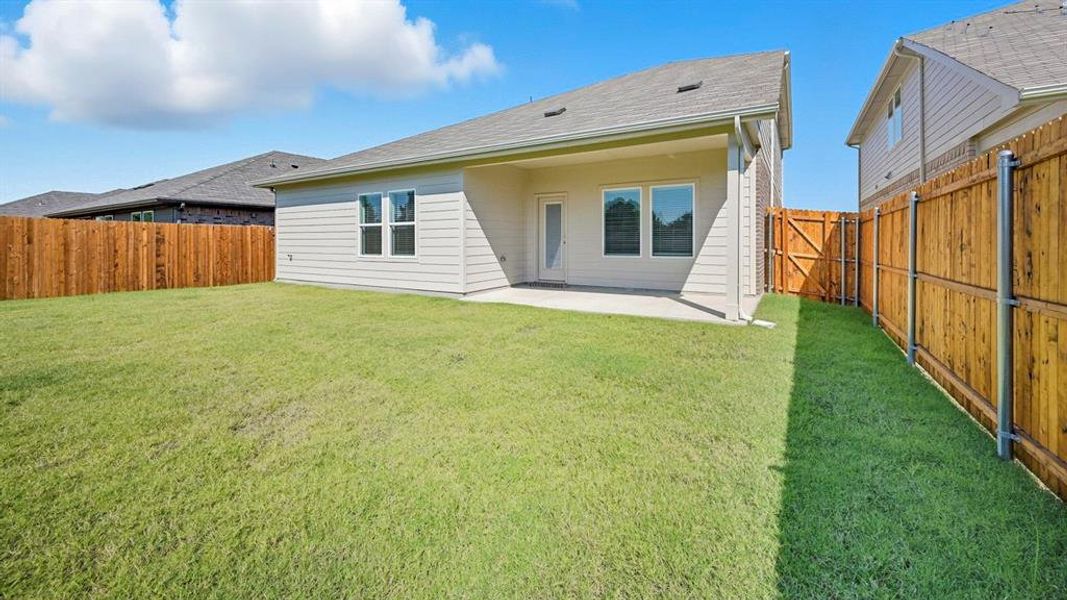 Back of property featuring a patio area, a fenced backyard, and a shingled roof