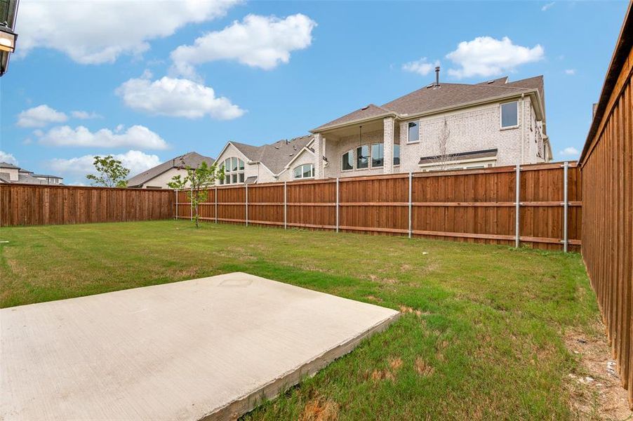 Fenced backyard with a patio and a residential view