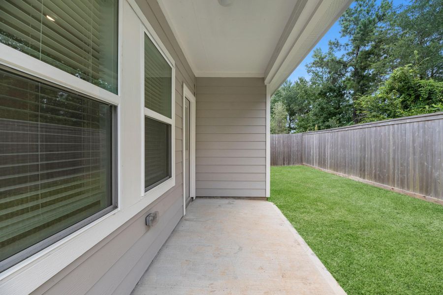 The covered patio is generously sized, providing ample space for various outdoor activities.