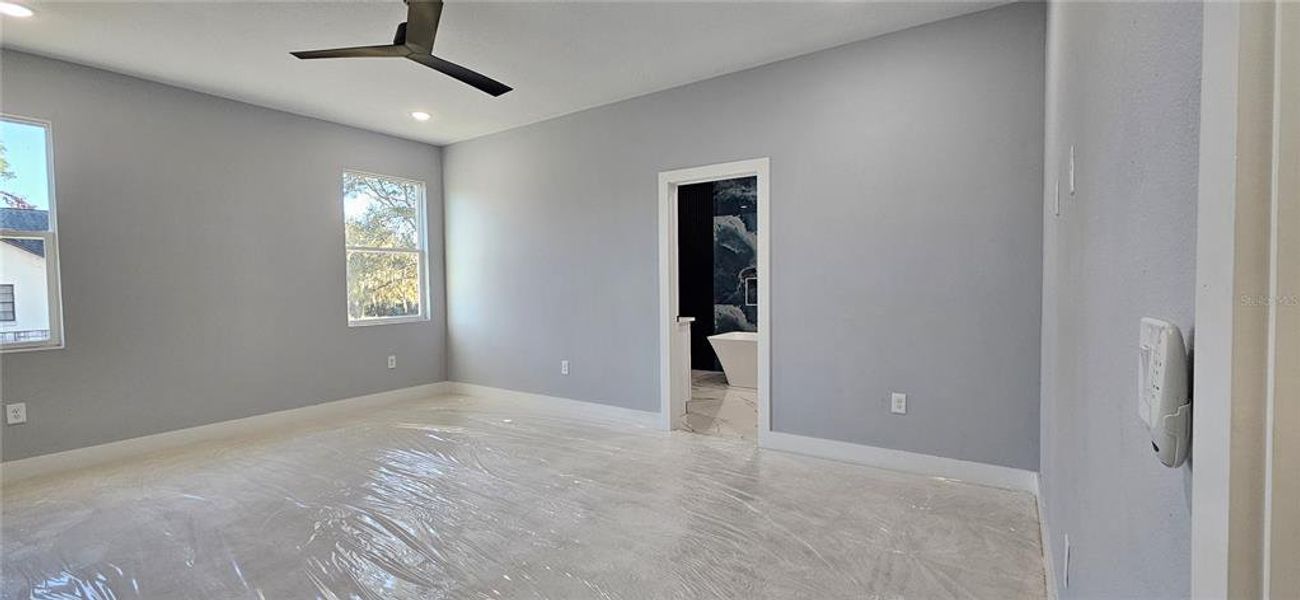 Master Bedroom toward Master Bath. New carpet covered in plastic.