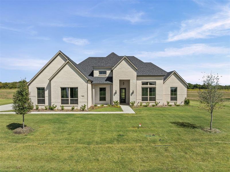 Front exterior of a new home in Waterfall Ranch - 1 Acre Lots, Waxahachie, TX, highlighting curb appeal (Image 1). Front exterior of a new home in Waterfall Ranch - 1 Acre Lots, Waxahachie, TX, highlighting curb appeal (Image 1).