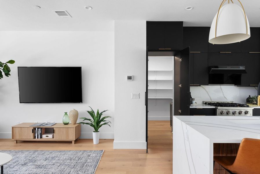 Speakeasy pantry with wine refrigerator is one of many custom details.