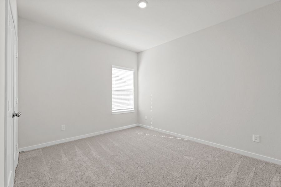 A room with a carpet and a window. A room with a carpet and a window.