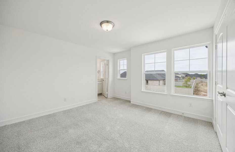 Comfortable secondary bedroom with generous closet space  *Real home pictured