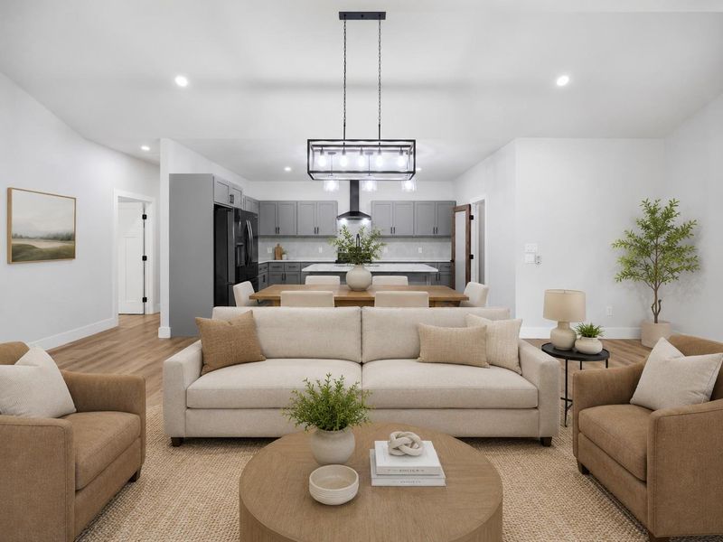 An open concept living area seamlessly flows into a modern kitchen, ideal for effortless entertaining. An open concept living area seamlessly flows into a modern kitchen, ideal for effortless entertaining.