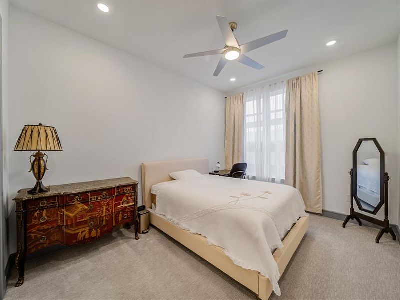 Bedroom featuring ceiling fan, light carpet, and recessed lighting