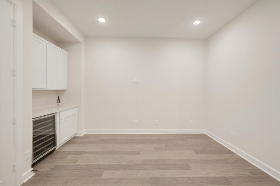 TV/Media room offers surround sound and a wine fridge/storage!