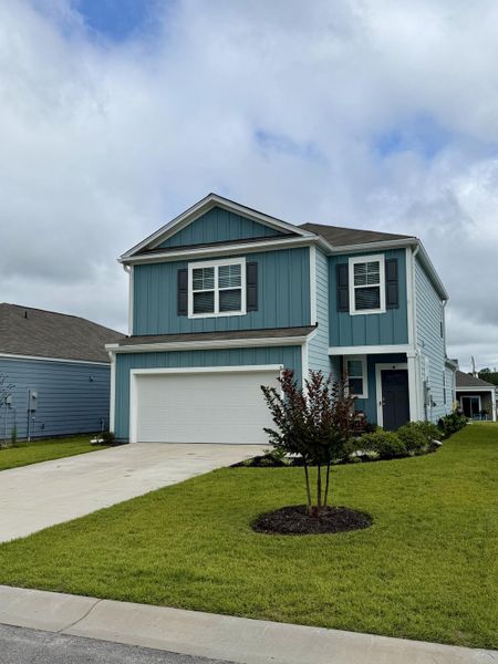 Front exterior of a new home in Hillcrest, Ravenel, SC, highlighting curb appeal (Image 1). Front exterior of a new home in Hillcrest, Ravenel, SC, highlighting curb appeal (Image 1).