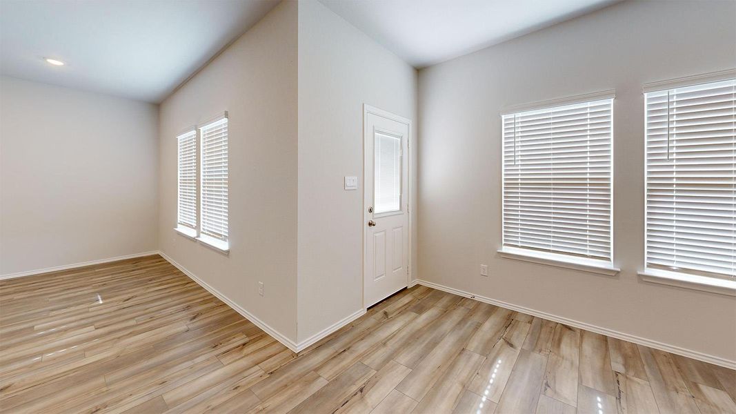 Entryway with baseboards and light wood finished floors
