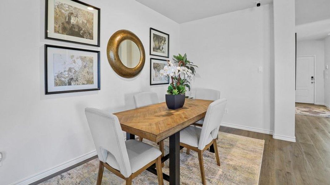 Dining area with wood finished floors and baseboards