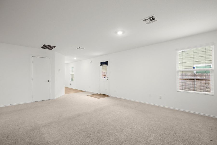 This gently lived-in single-story beauty features an open, sunlit layout with recessed lighting, cozy carpeting, and durable wood-look vinyl flooring - easy to care for and ideal for everyday living or tenant turnover.
