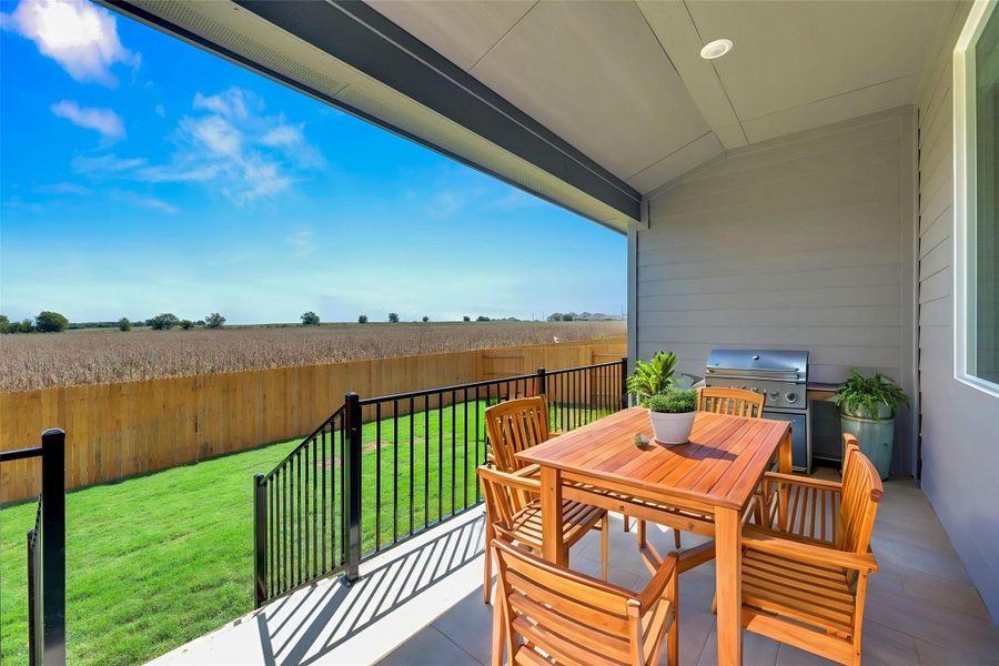 Balcony featuring outdoor dining space, an outdoor kitchen, and a sunroom Balcony featuring outdoor dining space, an outdoor kitchen, and a sunroom