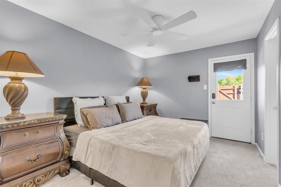 Carpeted bedroom featuring ceiling fan
