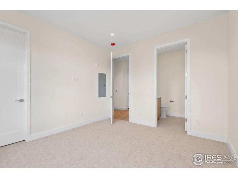 View of enusuite (right), hallway and closet (left) from secondary bedroom