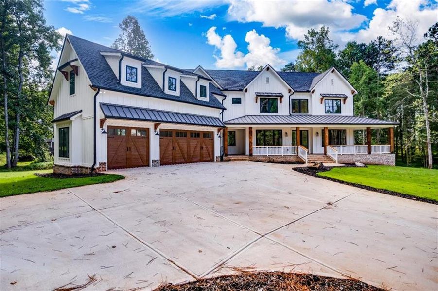 Front exterior of a new home in , Woodstock, GA, highlighting curb appeal (Image 1).
