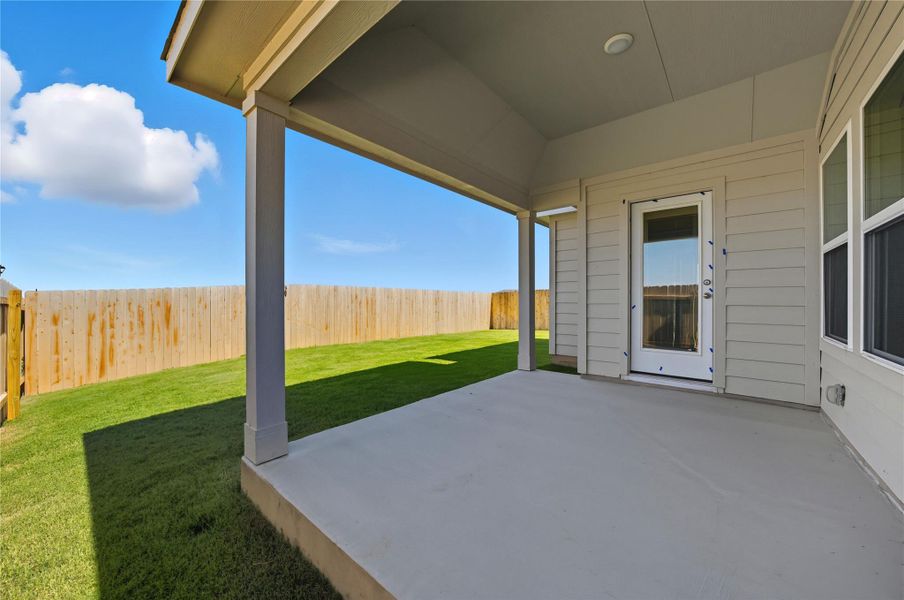 Fenced backyard featuring a patio area Fenced backyard featuring a patio area