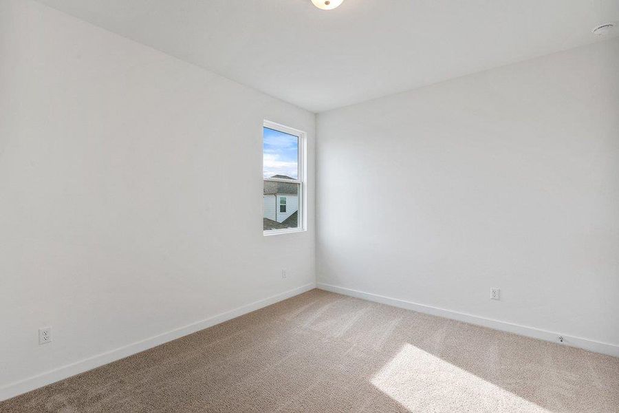 Empty room featuring baseboards and carpet floors