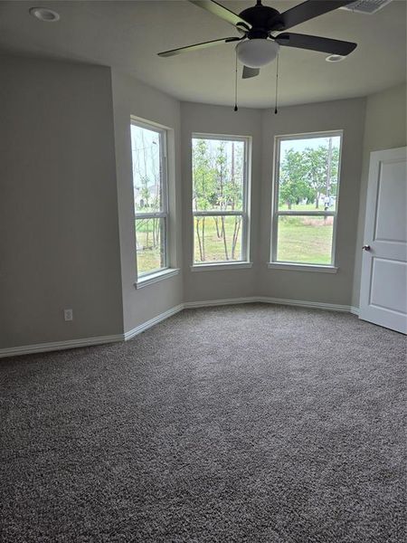 Spare room with carpet floors and ceiling fan