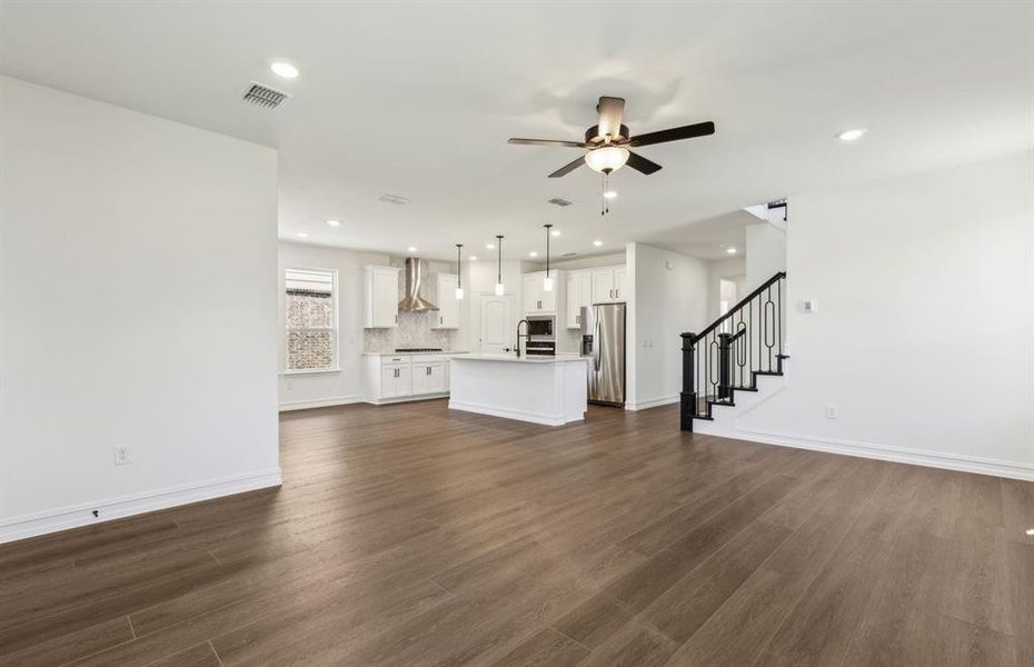Expansive gathering room bathed in natural sunlight *Real home pictured