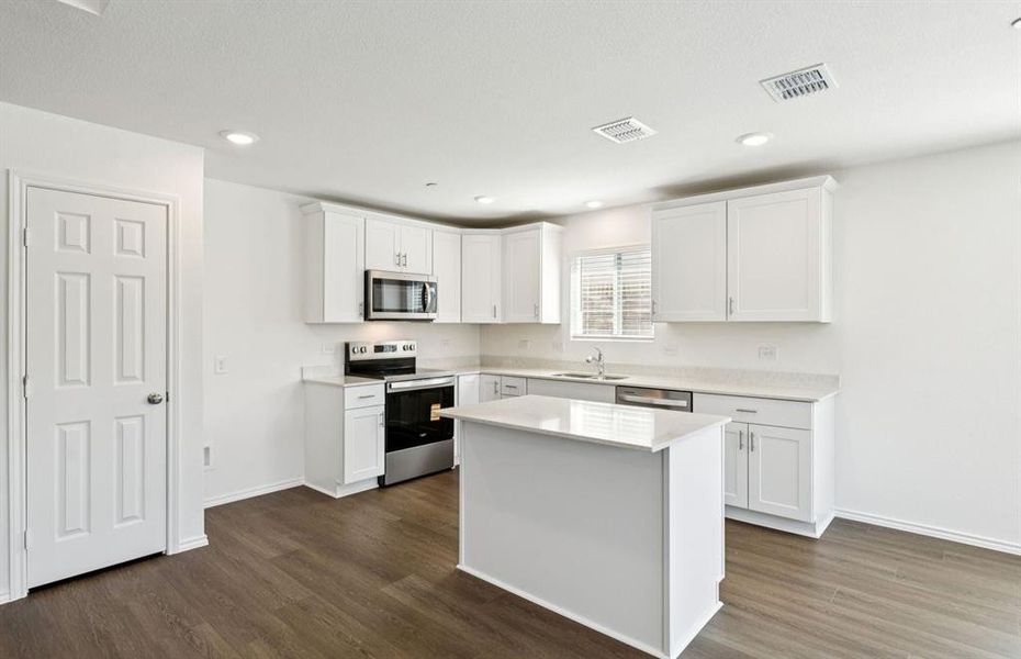 Spacious eat-in kitchen designed with a nice island for dining Spacious eat-in kitchen designed with a nice island for dining