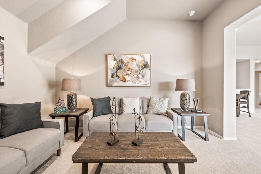 Living room with two gray sofas, rustic wood coffee table, and abstract wall art on beige walls Living room with two gray sofas, rustic wood coffee table, and abstract wall art on beige walls