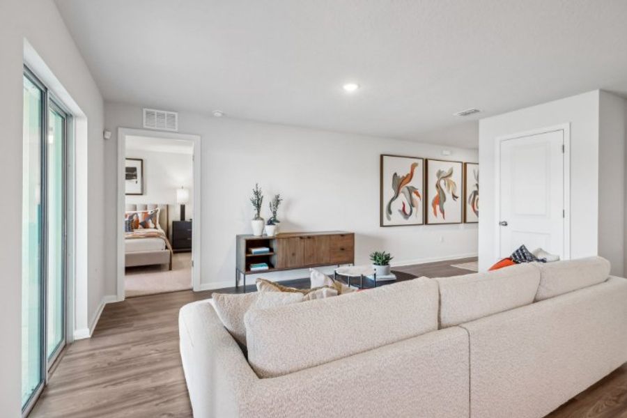 A living room with a couch and a table. A living room with a couch and a table.