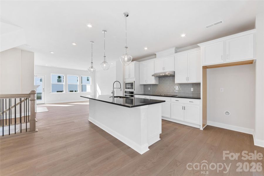 Gourmet Kitchen with White Cabinets and Concrete Grey QuartzCountertops