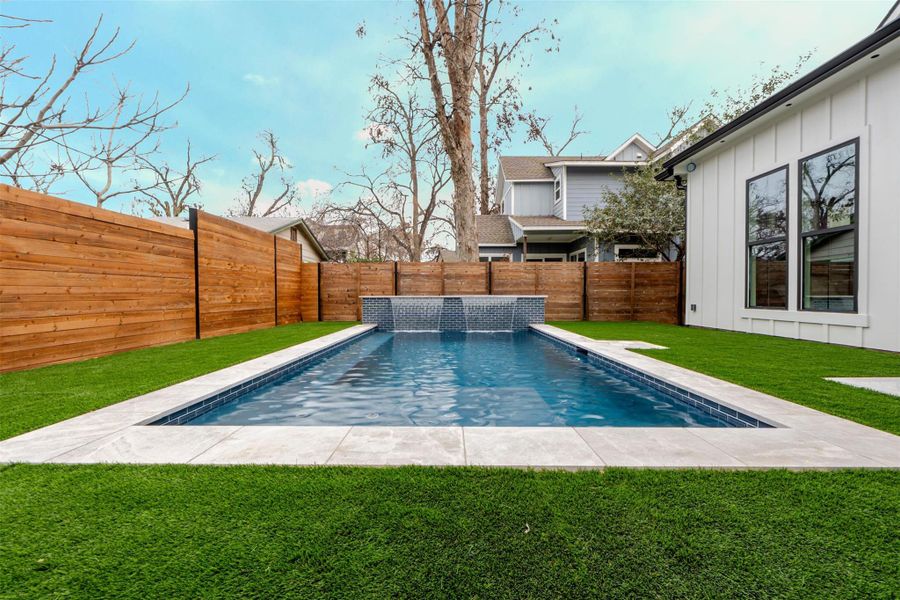 View of pool featuring a fenced backyard and patio surround