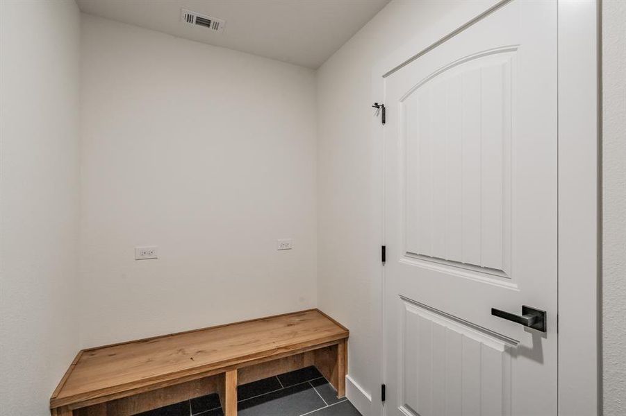 Mudroom with tile patterned flooring