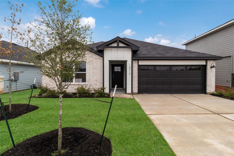 Front exterior of a new home in Monarch Ranch, Manor, TX, highlighting curb appeal (Image 21). Front exterior of a new home in Monarch Ranch, Manor, TX, highlighting curb appeal (Image 21).
