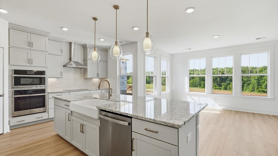Tasteful kitchen with oversized island and stylish pendant lighting—crafted to high standards located in Woodruff, SC