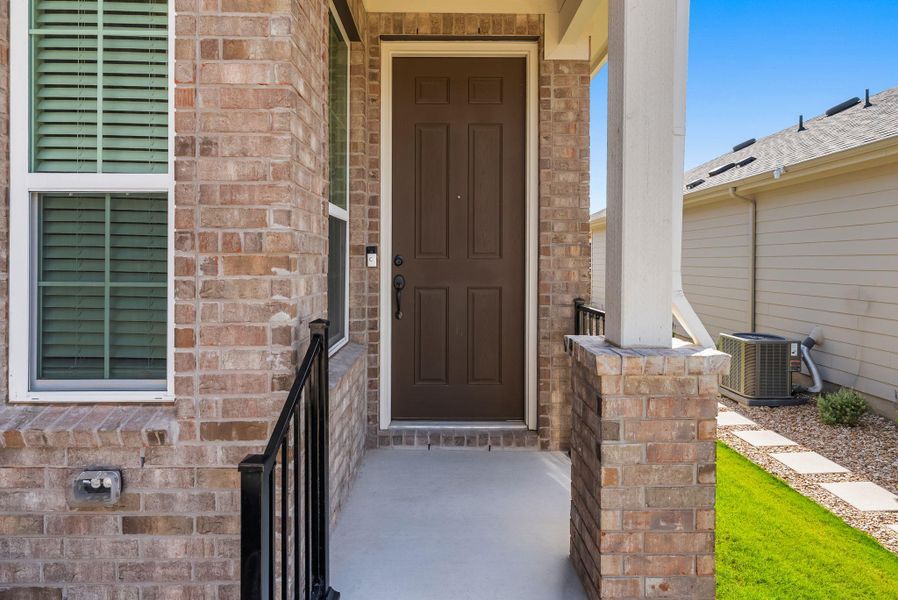 A welcoming brick facade with a classic paneled entry door and manicured front yard. A welcoming brick facade with a classic paneled entry door and manicured front yard.