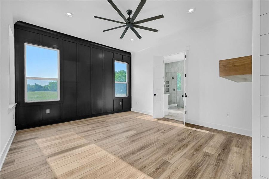 Unfurnished room with ceiling fan and light wood-type flooring