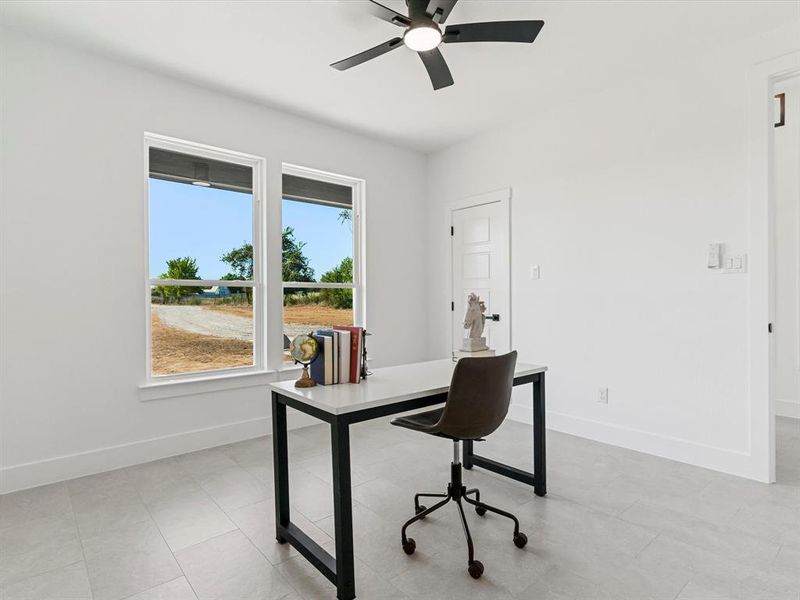 Home office featuring a ceiling fan and light tile patterned flooring