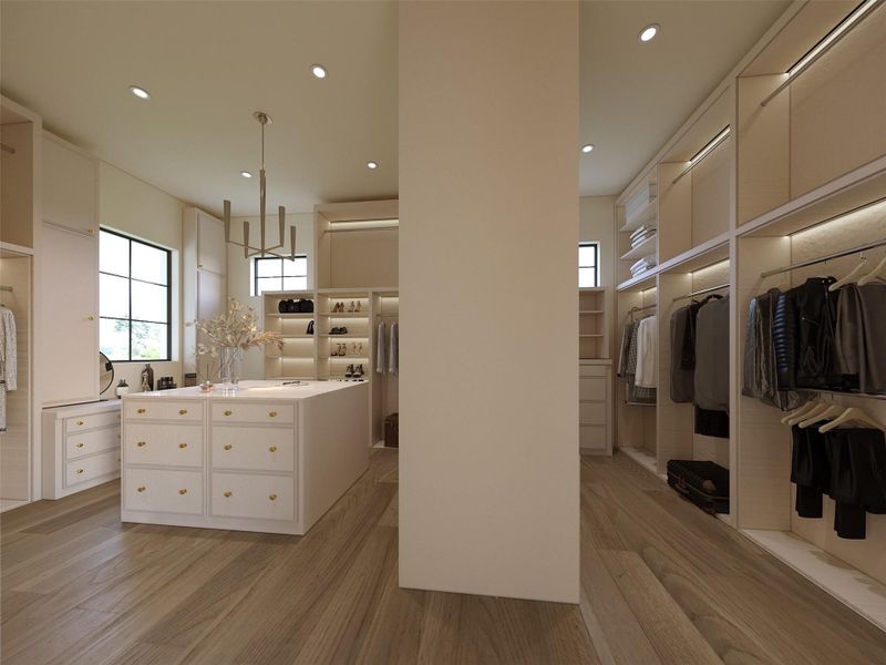 This boutique-style primary closet offers a luxurious dressing experience with custom built-ins, soft integrated lighting, and a statement island perfect for display and storage. This boutique-style primary closet offers a luxurious dressing experience with custom built-ins, soft integrated lighting, and a statement island perfect for display and storage.