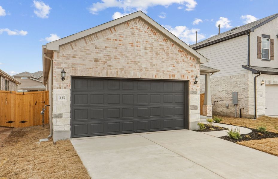 Front exterior of a new home in Crosswinds, Kyle, TX, highlighting curb appeal (Image 17).
