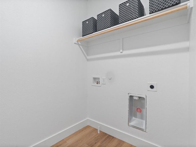 Clothes washing area with laundry area, baseboards, light wood-type flooring, electric dryer hookup, and washer hookup