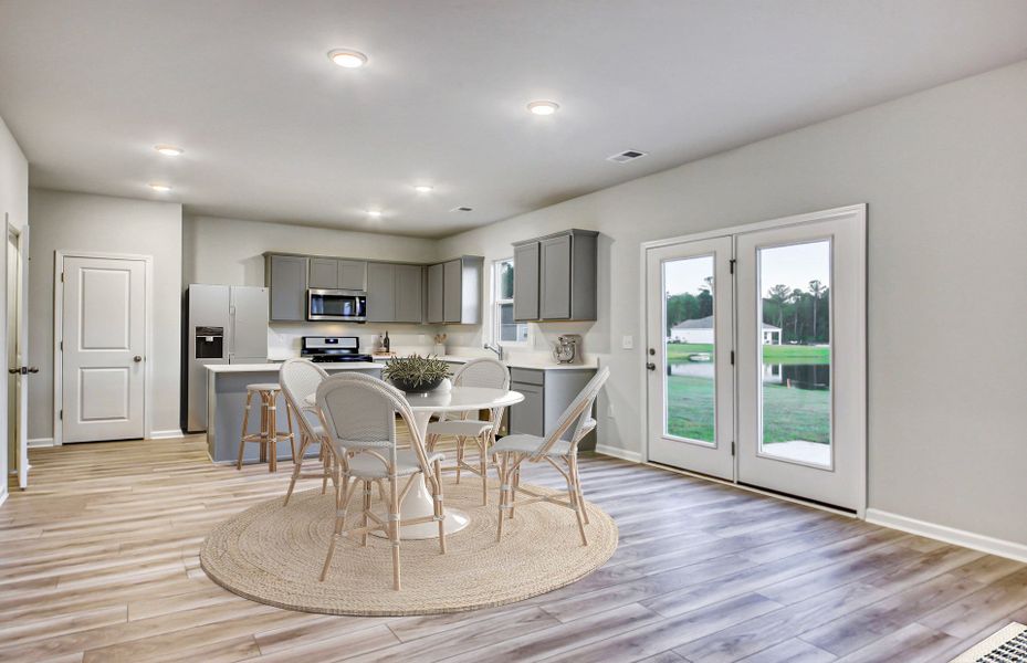 Spacious, open floorplan with hardwood floors and large windows.