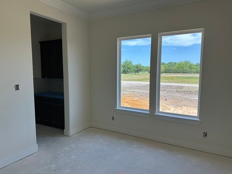 Bright interior space with two large windows featuring white trim